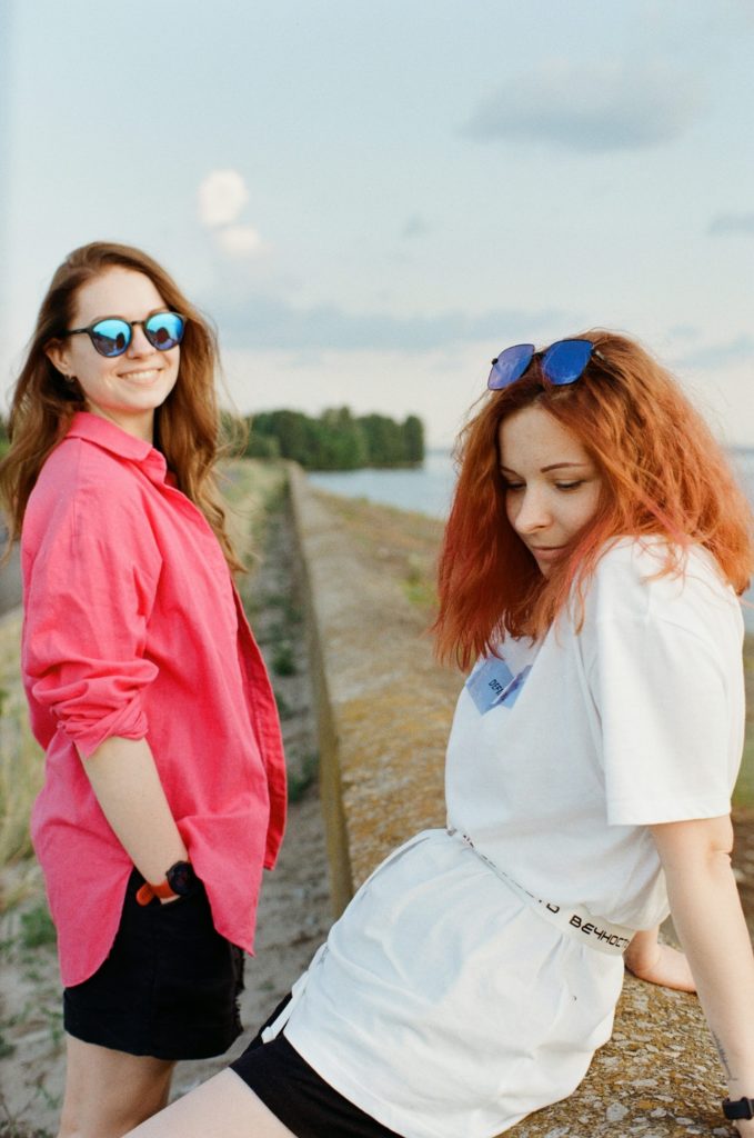 woman in white long sleeve shirt and blue framed sunglasses