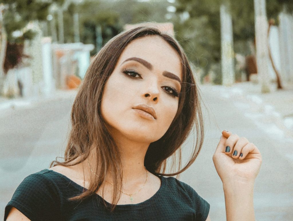 woman in black crew-neck top taking self portrait