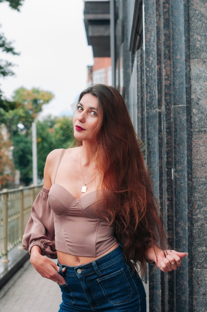 a woman leaning against a wall