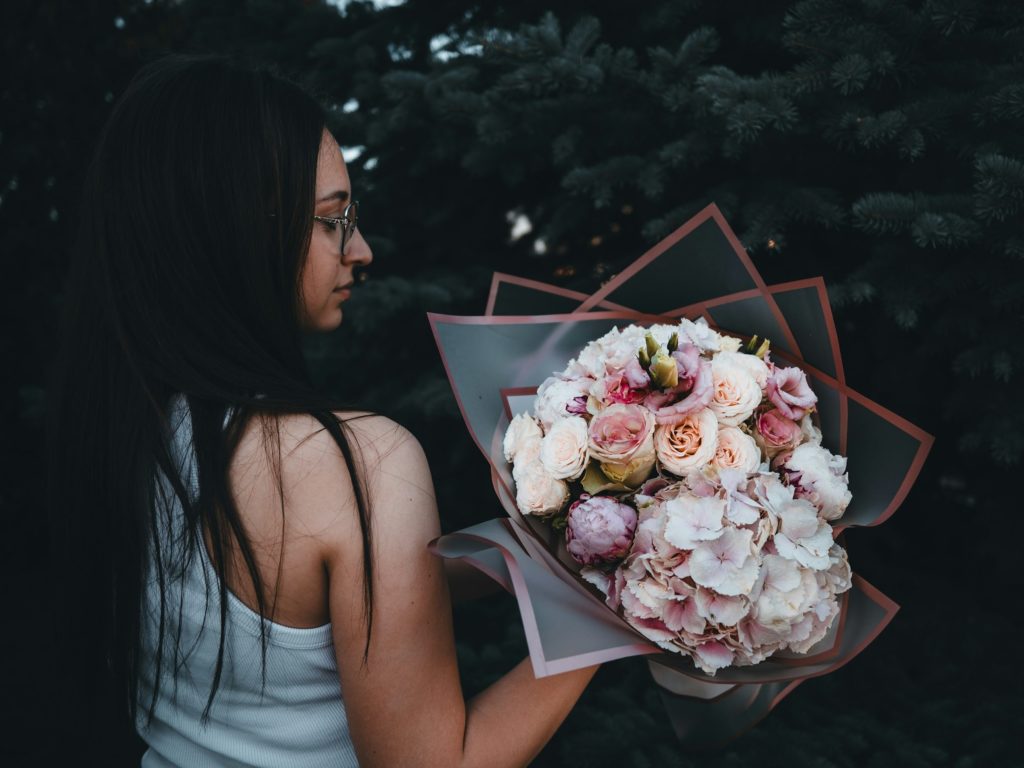 hungarian woman holding a bouquet of flowers in her hand