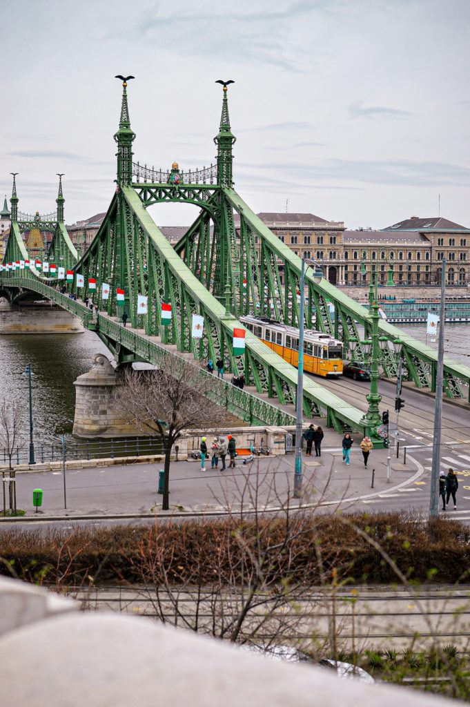 a green bridge with a train going over it in hungarian