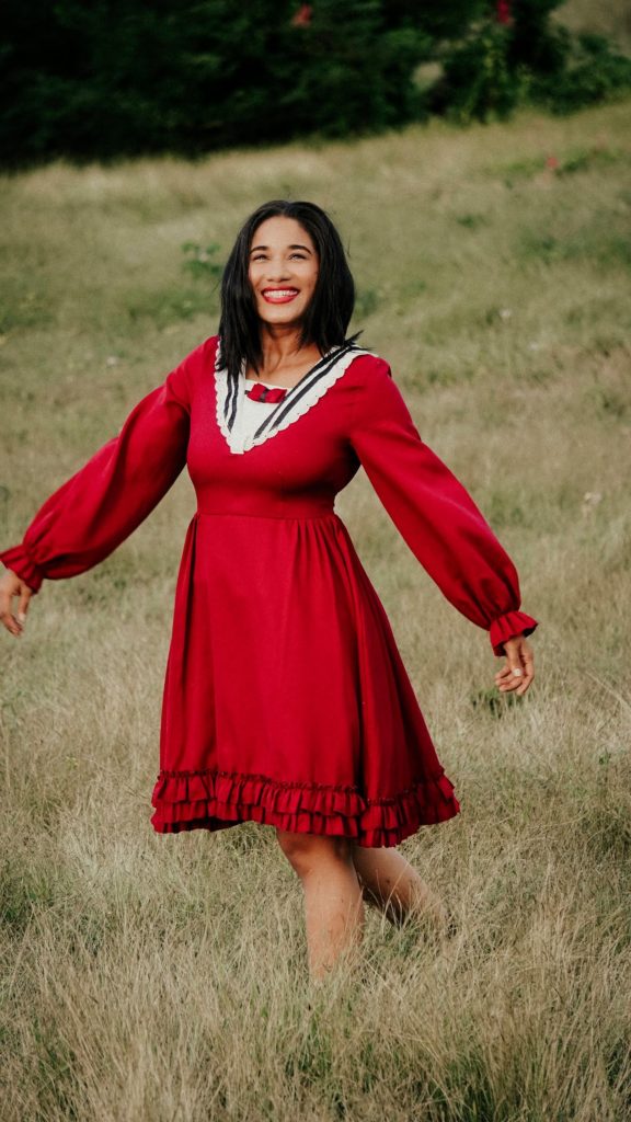 kyrgyzstan woman in a red dress standing in a field