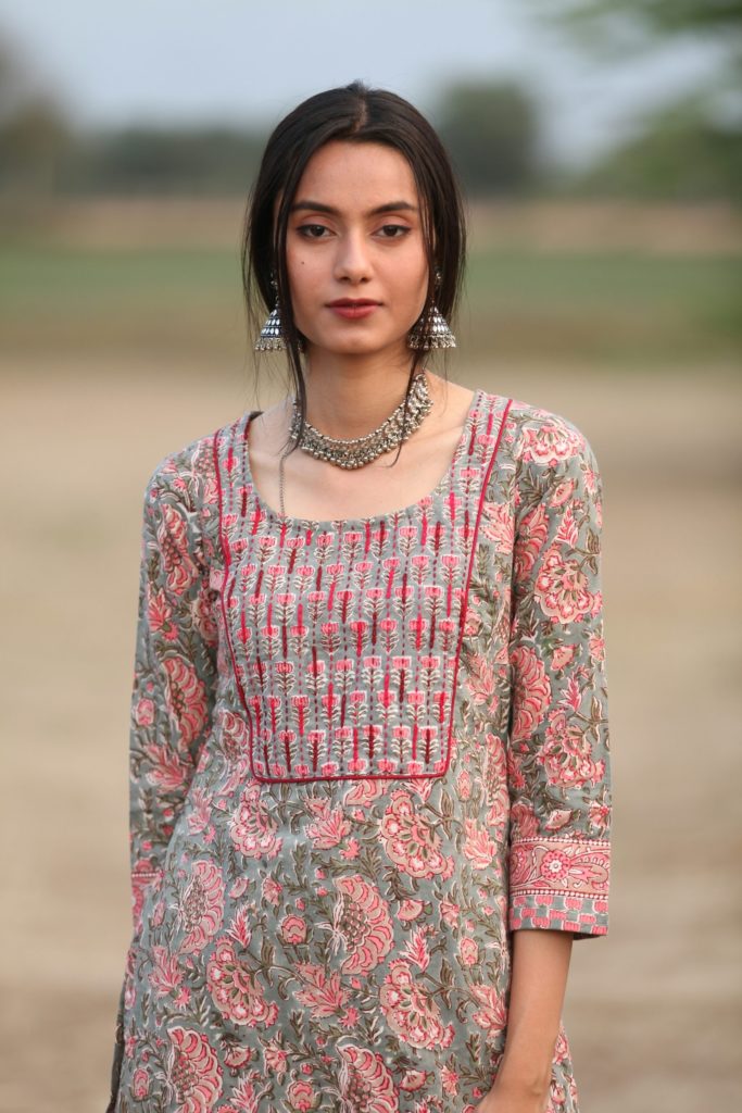 uzbekistan woman in a dress standing in a field