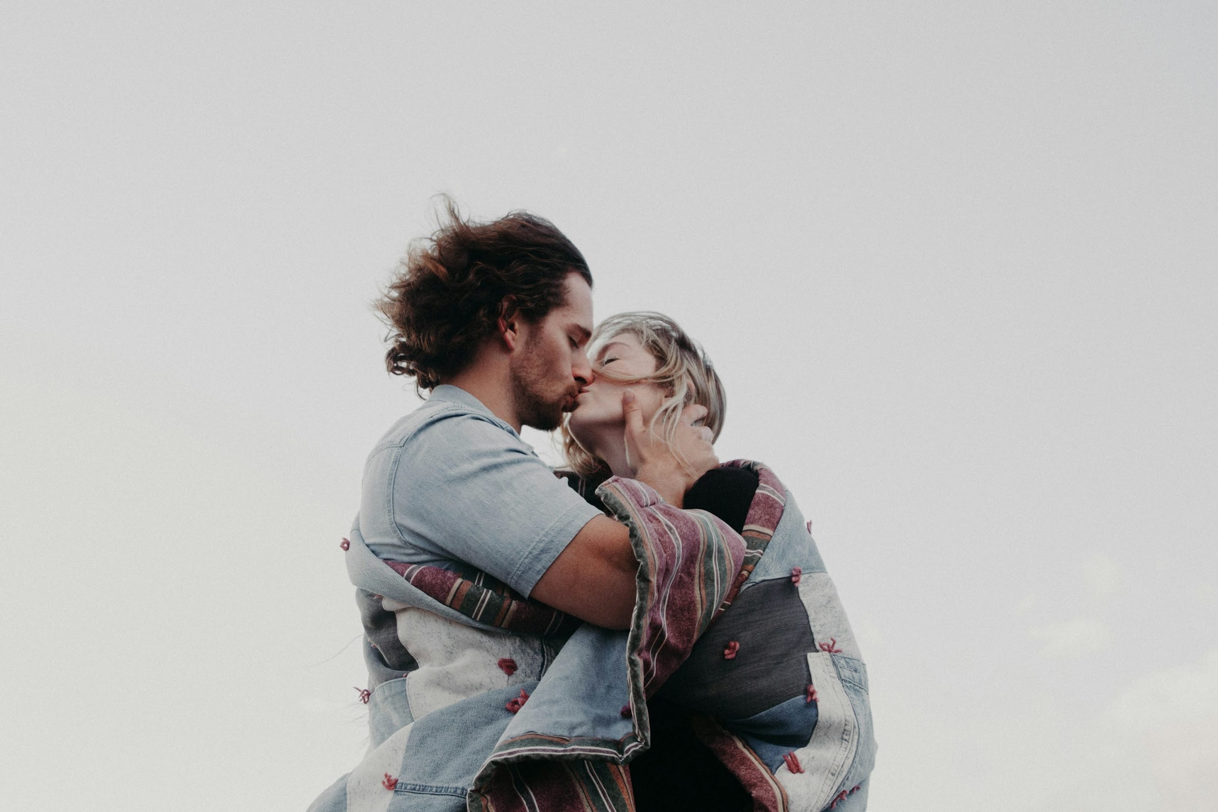 low angle photograph of man and woman kissing