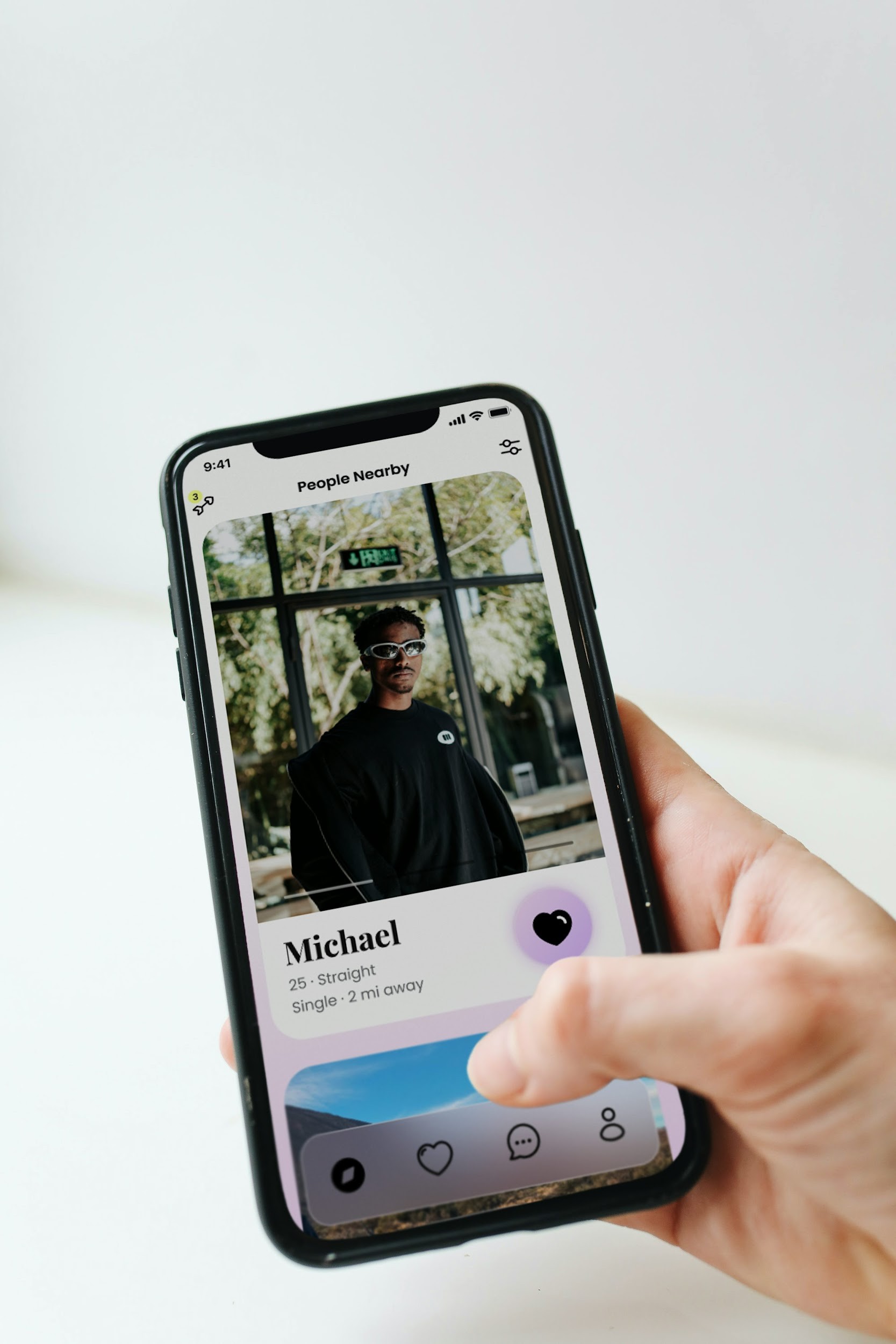 a person holding a cell phone with a picture of a man on it